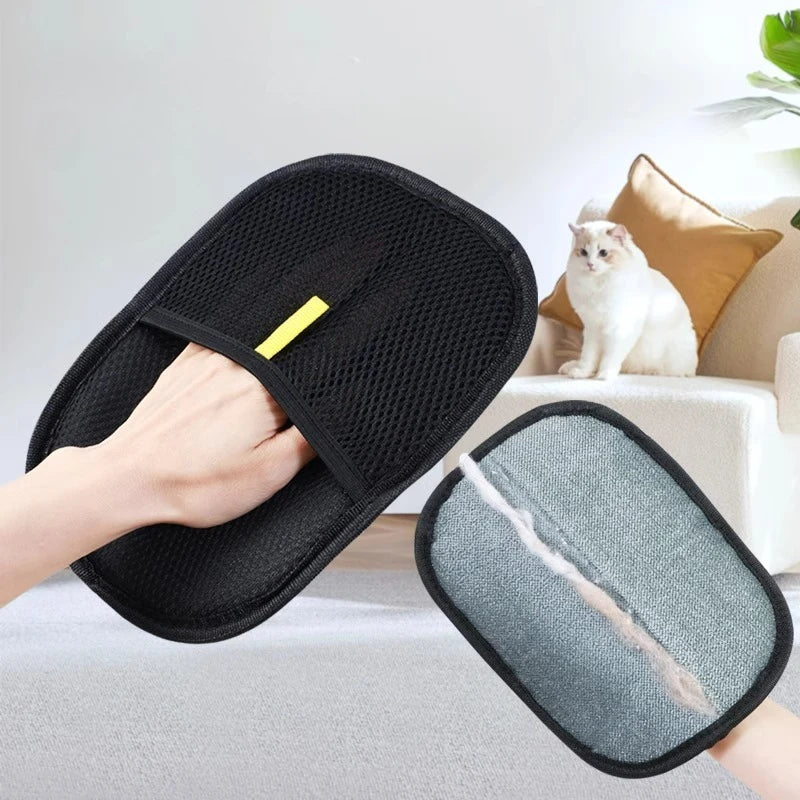 Black mesh cleaning pad held by a hand with a gray cleaning pad underneath, cat sitting on a couch in the background.