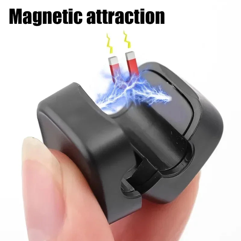 Black magnetic attraction device held between fingers with electrical effects illustrated.