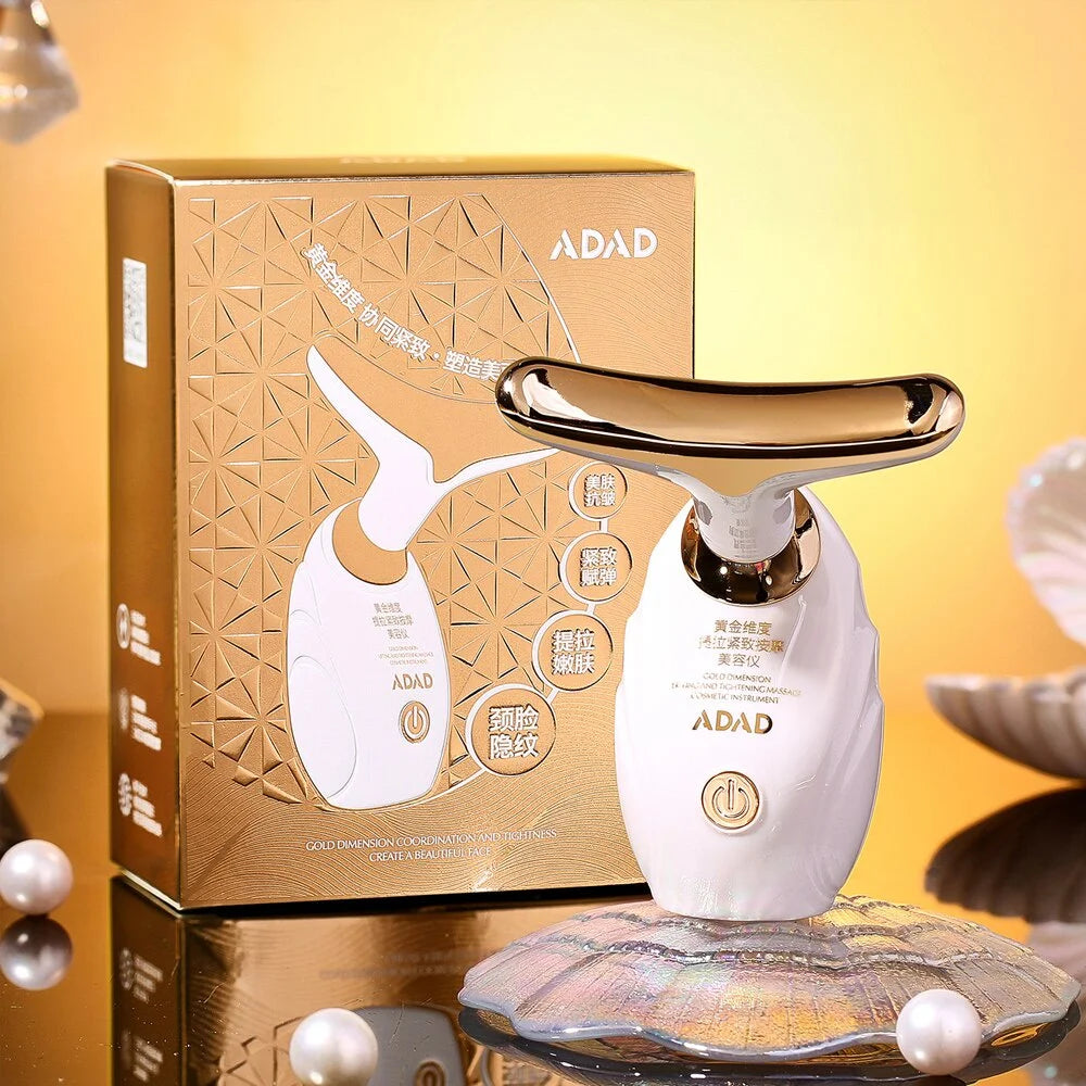 White beauty device with gold accents on a reflective surface, next to its packaging box with 'ADAD' branding.