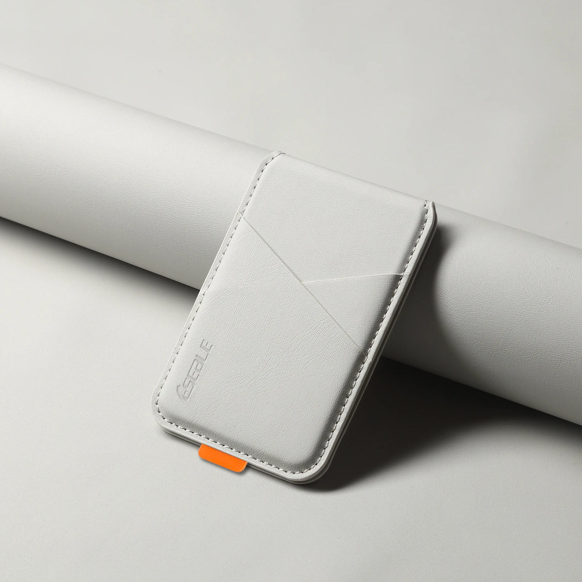 White phone case with orange tag on a light gray background
