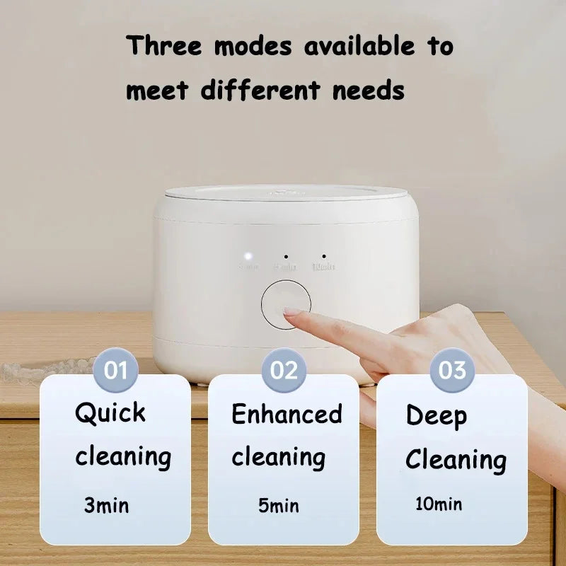 Hand pressing a button on a white appliance with cleaning mode labels displayed.